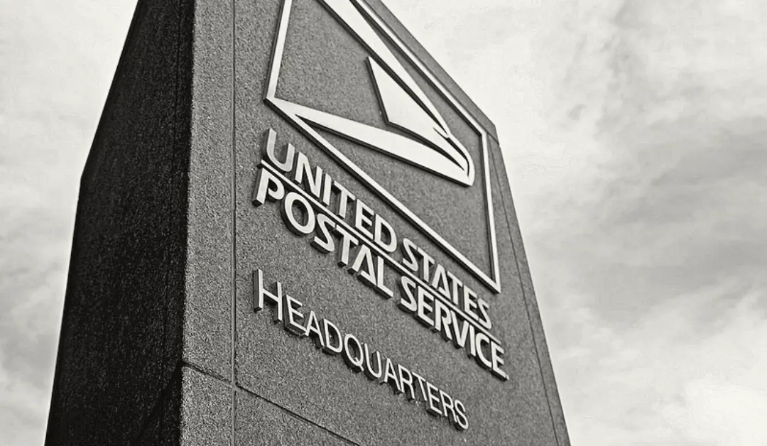 Postmaster General Louis DeJoy speaking at a press conference, announcing leadership changes at the U.S. Postal Service.
